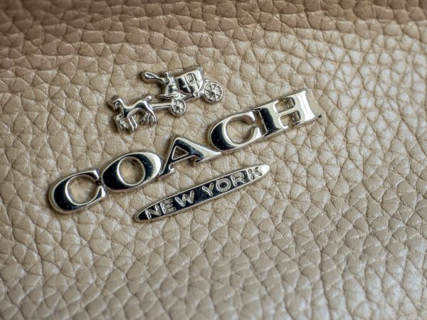 Macro detail of an authentic COACH logo embossing